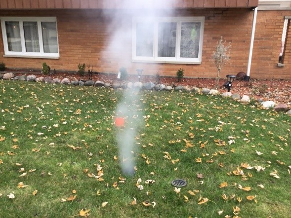 Smoke coming up from a front yard